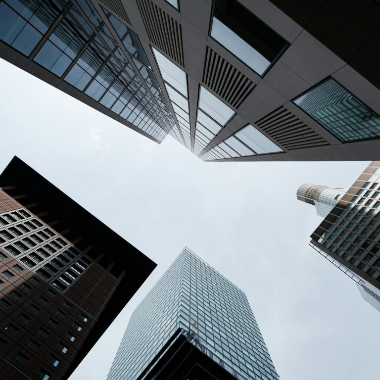 View of five tall office buildings against the sky