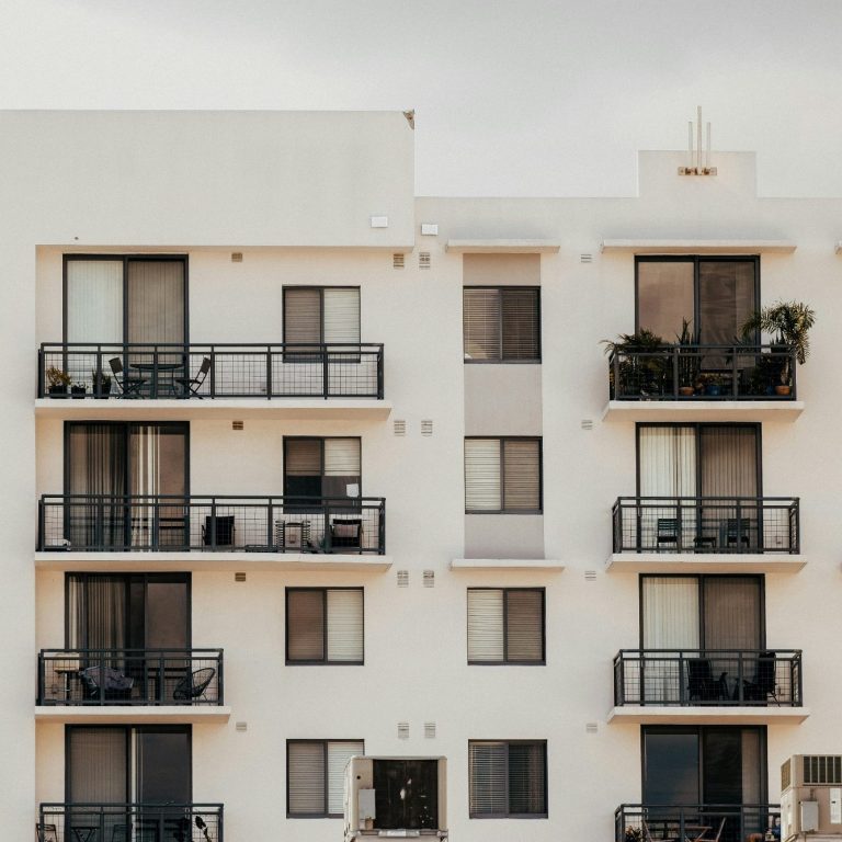 Multi-story residential building with balconies and multiple condos