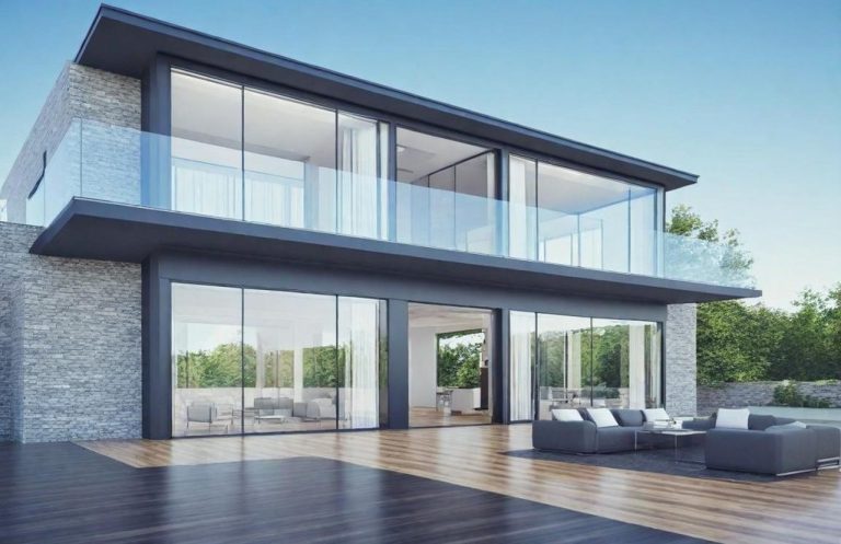 Two-story luxury home with outdoor seating area.